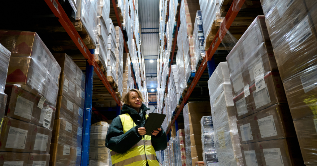 Cold storage worker in warehouse using tablet