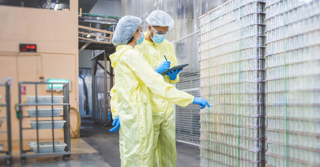 Warehouse workers using WMS to track inventory of products