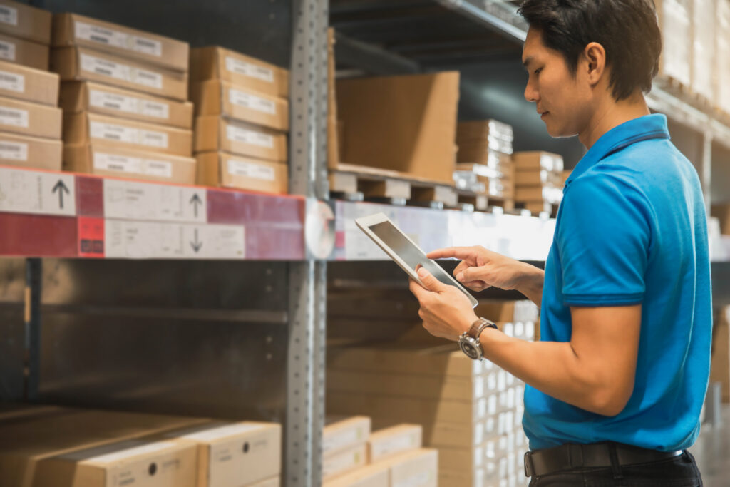 Business owner Using Tablet Computer In warehouse