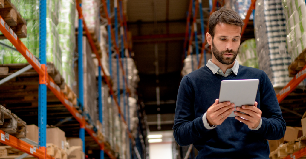 Warehouse worker using a tablet with an optimized WMS UX design interface during picking operations