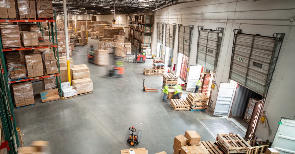Wideshot warehouse floor with workers