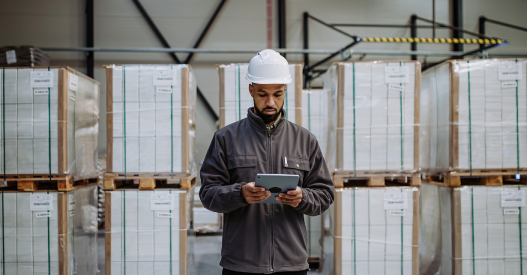 3PL warehouse worker reviewing inventory data on tablet