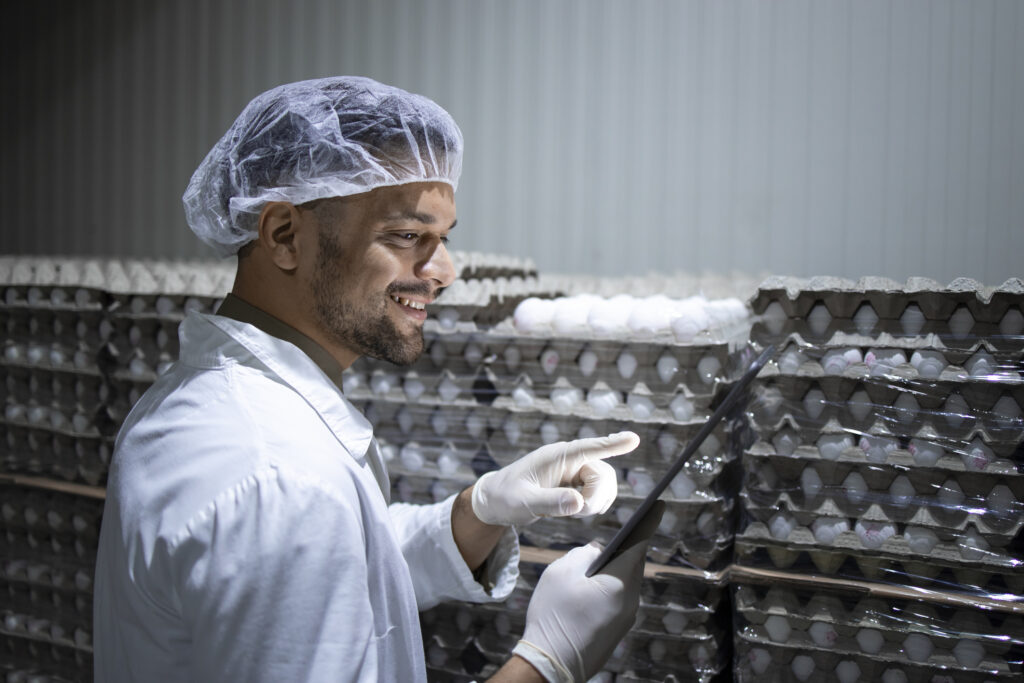 Cold storage warehouse worker scanning inventory for accurate tracking.