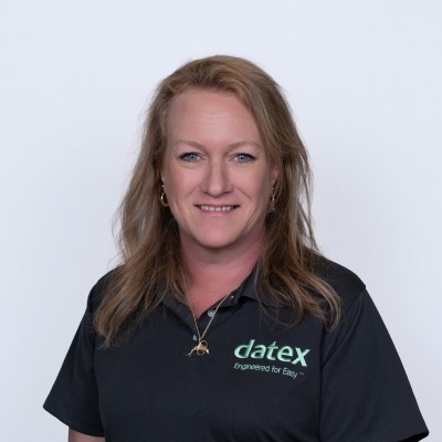 Professional headshot of person wearing Datex-branded polo shirt against plain light background
