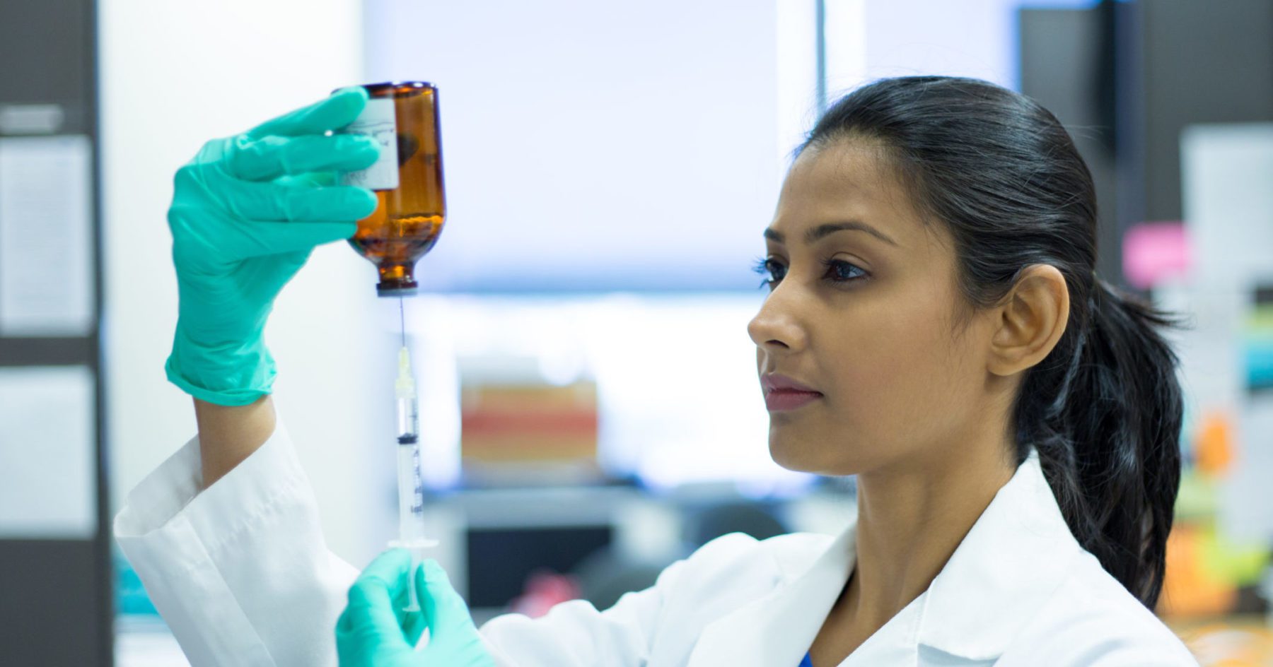 Doctor distributing pharmaceuticals with syringe 